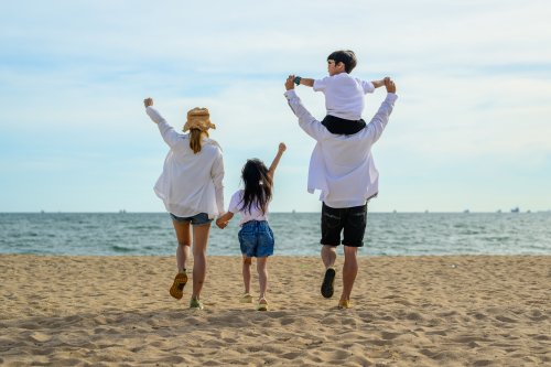 Happy Asian family travel together on beach on holiday, Family with beach travel, People enjoying with holiday vacation, Tropical beach vacation